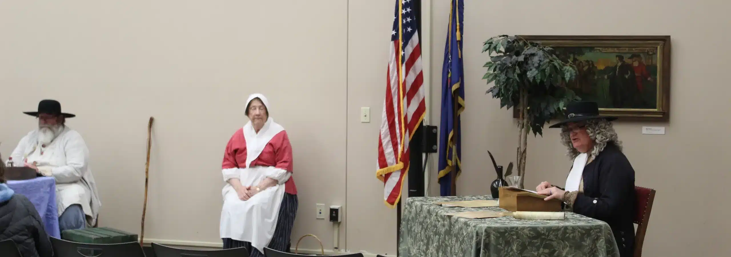 An actor playing William Penn and 2 other colonial actors are participating in a trial